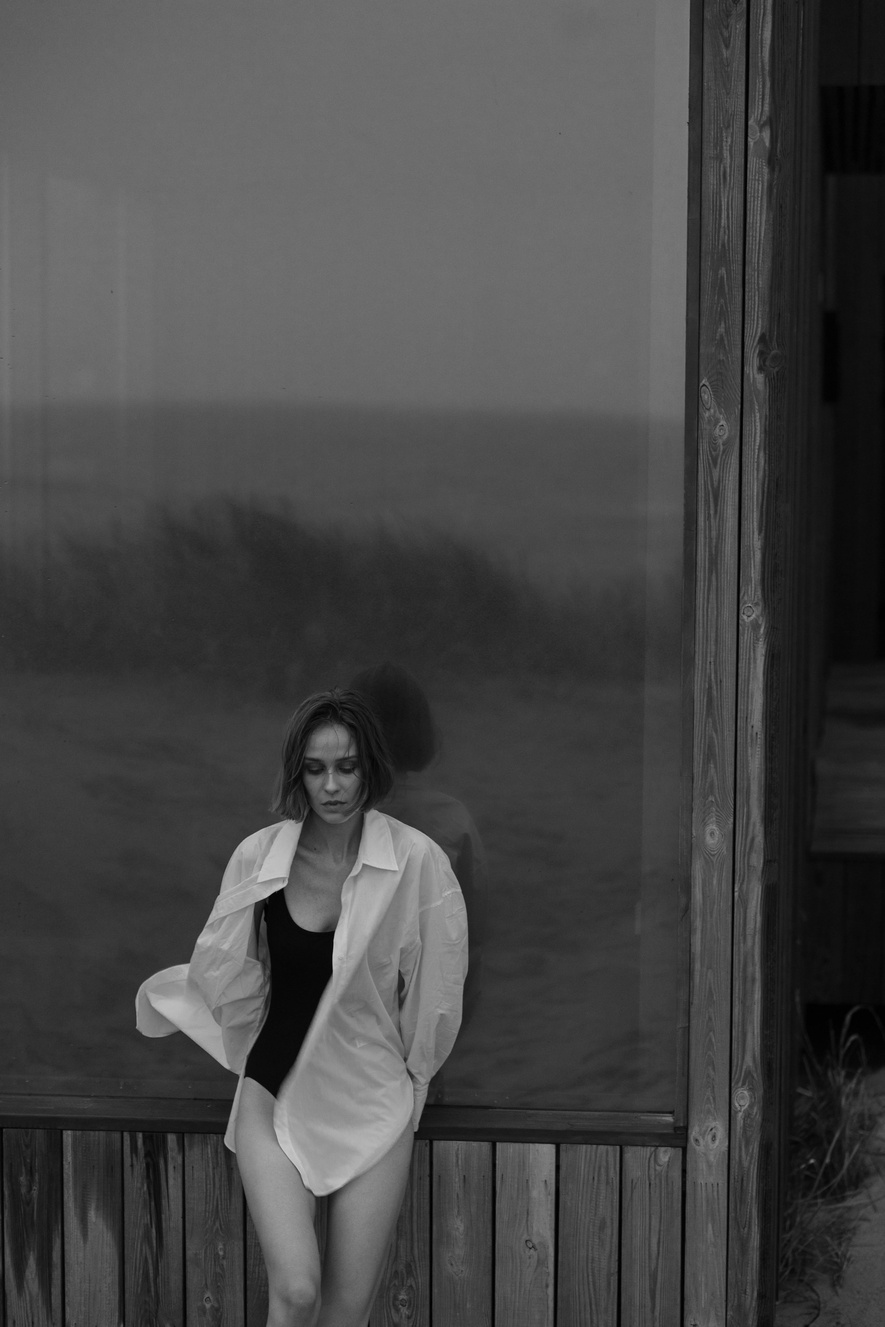 A Grayscale of a Woman Wearing a Button Up Shirt over a Bikini