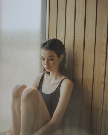 A Woman in a Bikini Sitting at a Corner