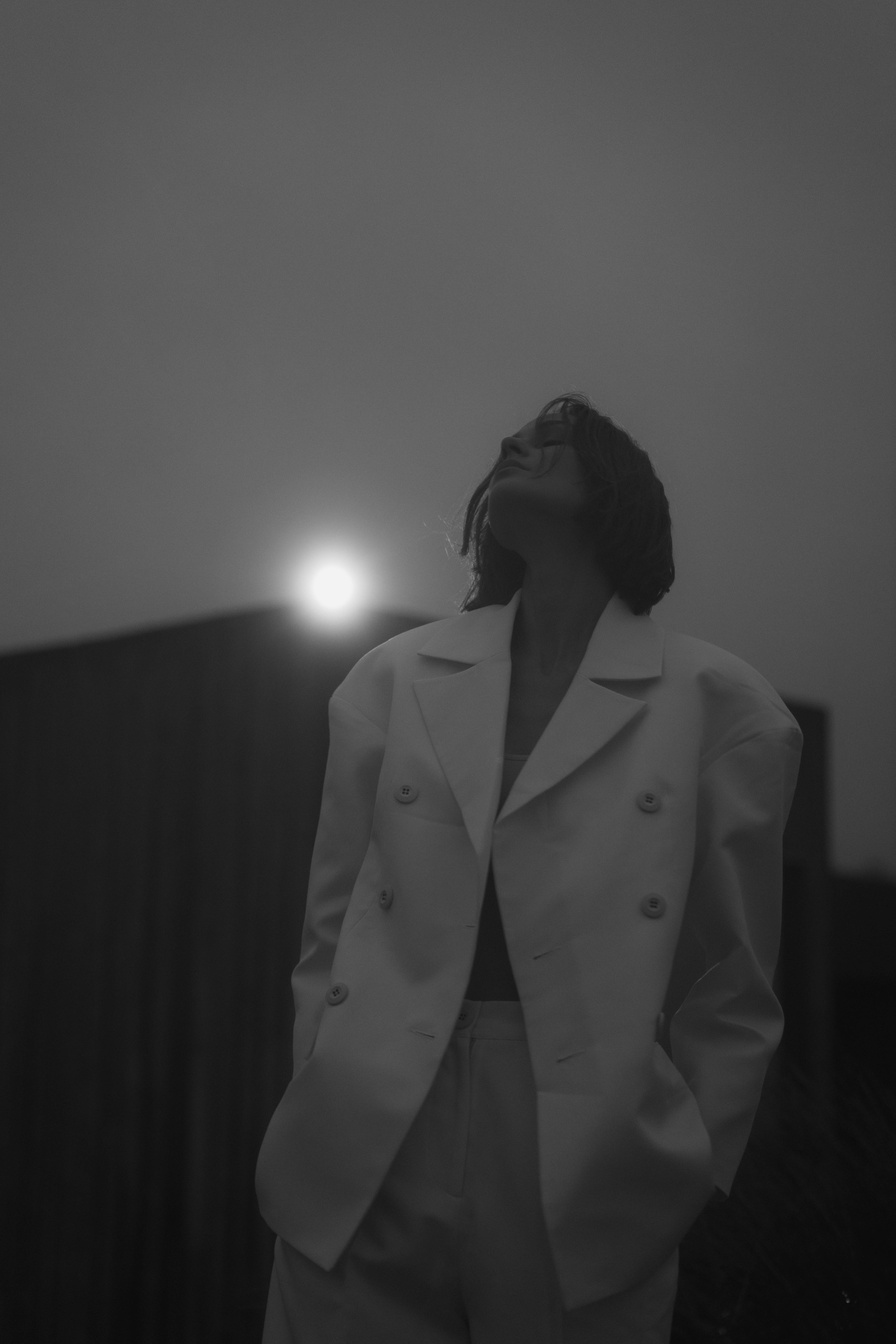 Woman in White Blazer Standing